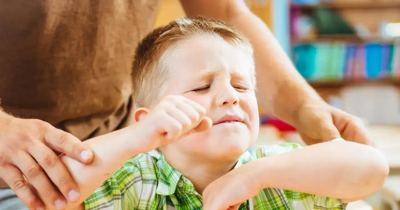 Chłopiec z ADHD, zaciśnięta pięść, zmartwiona mina. Jak postępować, by mu pomóc?